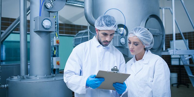 Food technicians working together in a food processing plant